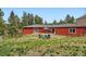 A view of the home's backyard showing a seating area and well-maintained grass at 4776 Red Rock Dr, Larkspur, CO 80118