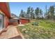 Outdoor patio area with umbrella, table, and chairs at 4776 Red Rock Dr, Larkspur, CO 80118