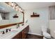 Updated bathroom features dual sinks, granite countertops, and wood-look tile flooring at 4776 Red Rock Dr, Larkspur, CO 80118