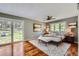 Cozy bedroom with natural light, sliding glass door, and wood floors at 4776 Red Rock Dr, Larkspur, CO 80118