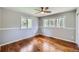Spacious bedroom featuring wood floors, ample windows for natural light, and modern trim work at 4776 Red Rock Dr, Larkspur, CO 80118