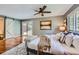 Comfortable bedroom featuring a sliding glass door, ceiling fan and beautiful natural light at 4776 Red Rock Dr, Larkspur, CO 80118
