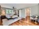 A stylish bedroom with hardwood floors, a ceiling fan, and a sliding barn door to closet at 4776 Red Rock Dr, Larkspur, CO 80118