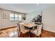 Elegant dining room with hardwood floors, stylish furniture, and natural light from the window at 4776 Red Rock Dr, Larkspur, CO 80118
