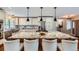 An open kitchen boasts a large granite island with bar seating and modern lighting at 4776 Red Rock Dr, Larkspur, CO 80118