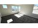 Light-filled bedroom with plush gray carpet and ample natural light at 2303 Peregrine Dr, Brighton, CO 80601