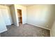 Bedroom with neutral paint, carpet, and access to the closet and other rooms at 2303 Peregrine Dr, Brighton, CO 80601