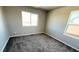 A bright bedroom with neutral paint, carpeted floor, and natural light at 2303 Peregrine Dr, Brighton, CO 80601