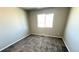 Carpeted bedroom with neutral paint and a window allowing lots of natural light at 2303 Peregrine Dr, Brighton, CO 80601