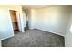 Carpeted bedroom with neutral paint and an open closet with built-in shelving at 2303 Peregrine Dr, Brighton, CO 80601