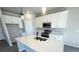 Modern kitchen featuring white cabinets, quartz countertops, and stainless steel appliances at 2303 Peregrine Dr, Brighton, CO 80601