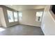 Bright and spacious living room with luxury vinyl flooring and big windows at 2303 Peregrine Dr, Brighton, CO 80601