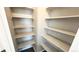 Walk-in pantry with lots of shelving for organized storage and convenience at 2303 Peregrine Dr, Brighton, CO 80601