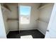 Walk-in closet with built in shelving and natural light from window with a view at 2303 Peregrine Dr, Brighton, CO 80601