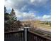 Enjoy a scenic view of trees, street and neighborhood from this cozy balcony with decorative wood railing at 2855 Rock Creek Cir # 129, Superior, CO 80027