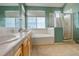 Spacious Primary bathroom featuring shower, tub, double sinks and light tile at 2855 Rock Creek Cir # 129, Superior, CO 80027