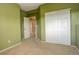Bright bedroom with neutral carpet, green walls, and a large closet at 2855 Rock Creek Cir # 129, Superior, CO 80027