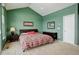 Cozy bedroom featuring green walls, a vaulted ceiling, and a comfortable queen-sized bed at 2855 Rock Creek Cir # 129, Superior, CO 80027