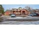 A brick community clubhouse with a turret and parking spaces in front at 2855 Rock Creek Cir # 129, Superior, CO 80027