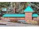 Sign for The Summit at Rock Creek community with a decorative stone and teal roof at 2855 Rock Creek Cir # 129, Superior, CO 80027