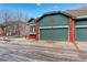 Home featuring an attached teal garage with brick accents, new construction, and modern details at 2855 Rock Creek Cir # 129, Superior, CO 80027