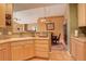 Bright kitchen with light wood cabinets, tile flooring, and stainless steel toaster appliance at 2855 Rock Creek Cir # 129, Superior, CO 80027