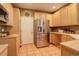 Functional kitchen with stainless steel refrigerator, ample cabinetry, and tile flooring at 2855 Rock Creek Cir # 129, Superior, CO 80027
