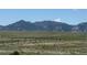 A beautiful mountain view with vibrant greenery, power lines, and a fence at 2855 Rock Creek Cir # 129, Superior, CO 80027