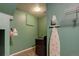 Functional laundry room with a washer, storage, and an ironing board at 2855 Rock Creek Cir # 129, Superior, CO 80027
