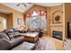 Inviting living room with vaulted ceiling, fireplace, large windows, and comfortable leather furniture set at 2855 Rock Creek Cir # 129, Superior, CO 80027
