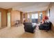 Spacious living room with a fireplace, plush carpeting, and plenty of natural light from the large sliding door at 2855 Rock Creek Cir # 129, Superior, CO 80027