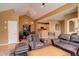 Cozy living room with leather furniture, hardwood floors, and open layout to the kitchen at 2855 Rock Creek Cir # 129, Superior, CO 80027