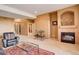 Inviting living room with a fireplace, plush seating, and neutral carpeting at 2855 Rock Creek Cir # 129, Superior, CO 80027