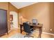 Cozy home office with hardwood floors, warm lighting, and a view into the home at 2855 Rock Creek Cir # 129, Superior, CO 80027