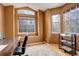 Home office with large windows, hardwood floors, and built-in shelving at 2855 Rock Creek Cir # 129, Superior, CO 80027