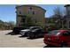 An exterior view of the parking lot with various cars parked at 2855 Rock Creek Cir # 129, Superior, CO 80027