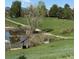 Scenic view of a pond with walking path and greenery in a peaceful community at 2855 Rock Creek Cir # 129, Superior, CO 80027