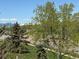 Scenic view of trees, lawn, and a road with mountains in the distance on a clear day at 2855 Rock Creek Cir # 129, Superior, CO 80027
