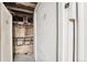 Basement storage area with numbered doors and exposed piping on the ceiling and walls at 1351 N Washington St # 15, Denver, CO 80203