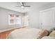 Well-lit bedroom featuring hardwood floors, a ceiling fan, and white trim and doors at 1351 N Washington St # 15, Denver, CO 80203