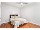 Bright bedroom featuring hardwood floors, ceiling fan, white doors, and neutral walls at 1351 N Washington St # 15, Denver, CO 80203