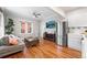 Open floor plan with hardwood floors, exposed brick, and modern appliances at 1351 N Washington St # 15, Denver, CO 80203