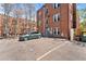 Reserved parking spots in front of this brick building with mature trees create an inviting atmosphere at 1351 N Washington St # 15, Denver, CO 80203