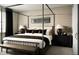 Serene bedroom featuring a four-poster bed, neutral decor, and plenty of natural light at 4125 N Duquesne Ct, Aurora, CO 80019