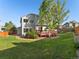 Picture of the backyard, showing a well-maintained lawn, trees, garden, deck, and the home's exterior at 16212 Blueleaf Pl, Parker, CO 80134