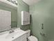 Cozy powder bathroom with white vanity, neutral flooring, and ample lighting at 16212 Blueleaf Pl, Parker, CO 80134
