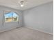 Bright bedroom with large window and neutral-colored walls and carpet flooring at 16212 Blueleaf Pl, Parker, CO 80134