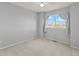 Bright bedroom with a large window offering views and neutral colored walls and carpet flooring at 16212 Blueleaf Pl, Parker, CO 80134