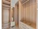 Custom closet with wooden shelves, drawers, hanging rods, and wire basket storage at 16212 Blueleaf Pl, Parker, CO 80134