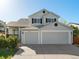 A well-maintained home featuring a three car garage and manicured landscaping at 16212 Blueleaf Pl, Parker, CO 80134